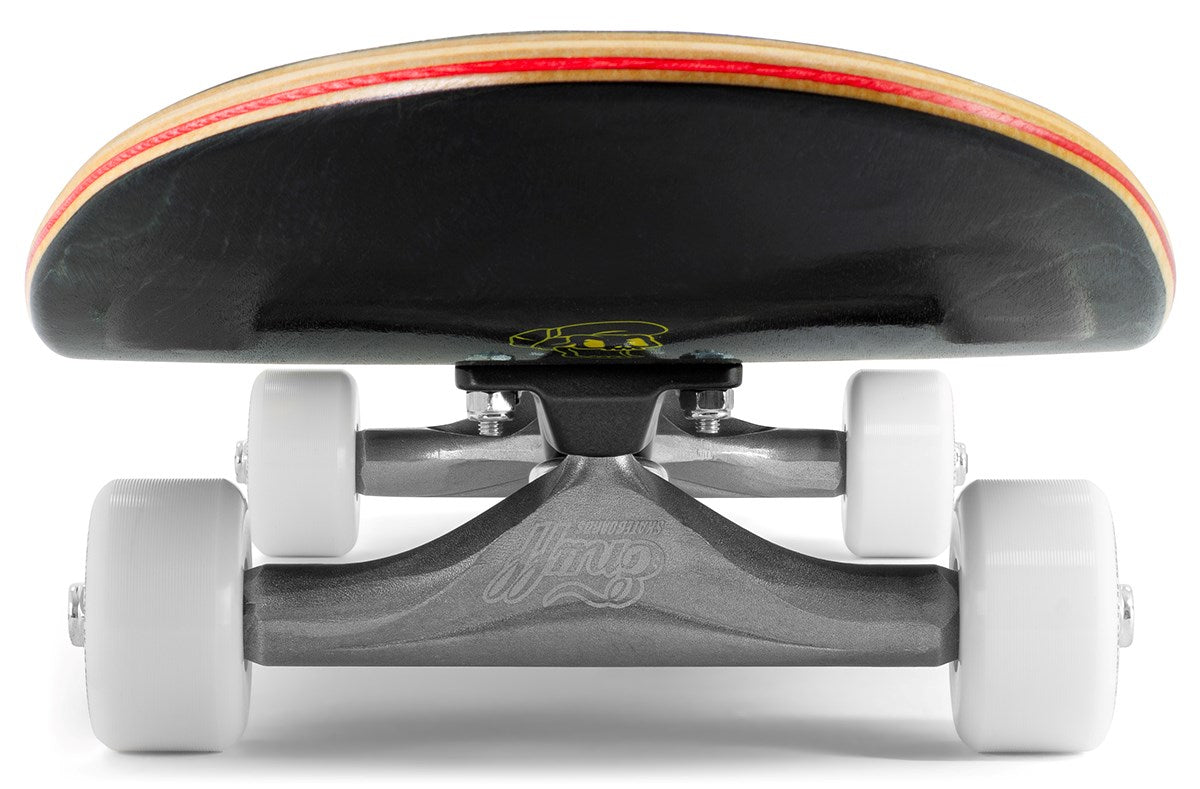 Ground-level close-up of the Enuff Three Tier Reloaded Black Complete Skateboard (8.0" x 32.0") by Enuff, featuring white wheels, silver trucks, and a black deck underside with a yellow design.