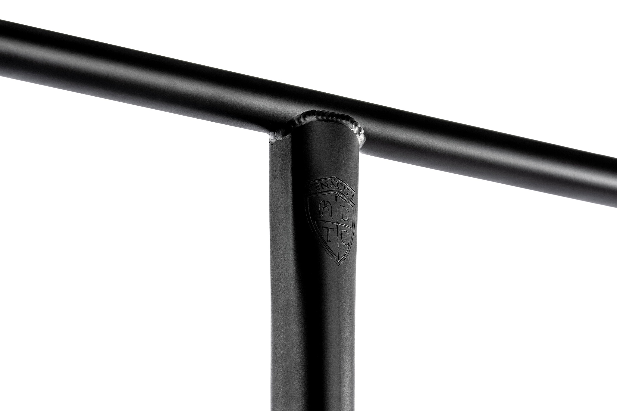 Close-up of a black Ethic DTC Tenacity V2 Oversized HIC Stunt Scooter T-Bar (770mm x 600mm) in durable 4130 chromoly steel, showing weld marks and an embossed ADTC shield logo on the upright bar, against a white background.