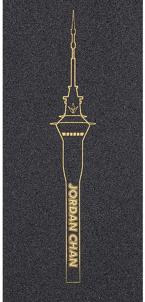 A black background features a gold line illustration of a tall tower inspired by the sleek design of a Blunt Envy scooter. The vertical text “JORDAN CHAN” appears on the tower, echoing the premium style of the Blunt Envy AOSV6 Stunt Scooter Griptape – Jordan Chan Signature.