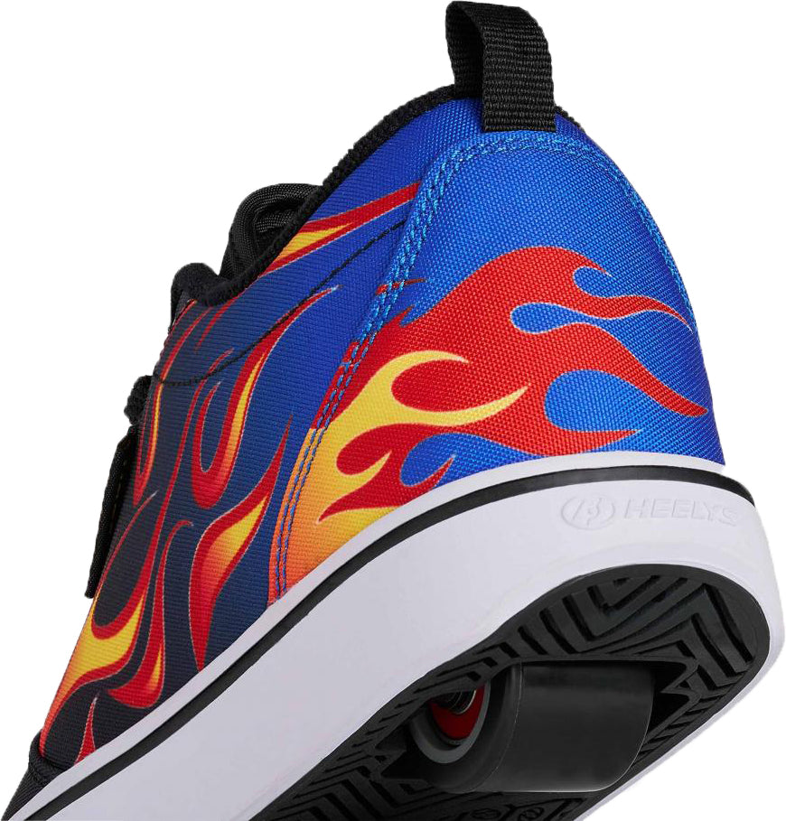 A close-up of the Heelys Pro 20 Prints Boys Shoes by Heelys in black, blue, red, and yellow—showcasing bold flame designs and a single wheel embedded in the white heel for standout style and attitude.
