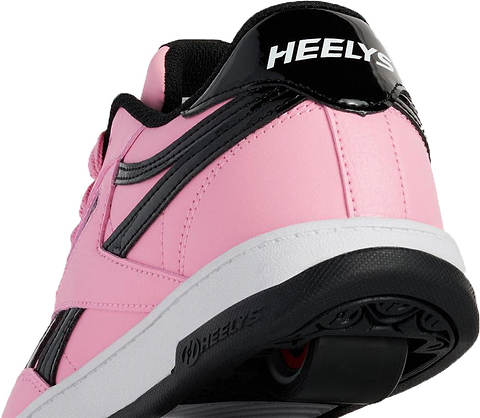 Close-up of the Heelys x Reebok Club C Girls Shoes - Candy Pink / Black / White, featuring a visible wheel in the sole and “HEELY” text—perfect for fans of girls shoes and rolling shoes.