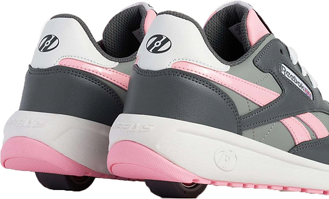 The Heelys x Reebok Classic Girls Shoes - Grey / Pink / White feature pink soles, black wheels in the heels, and combine classic sneaker style with fun roller shoe functionality.