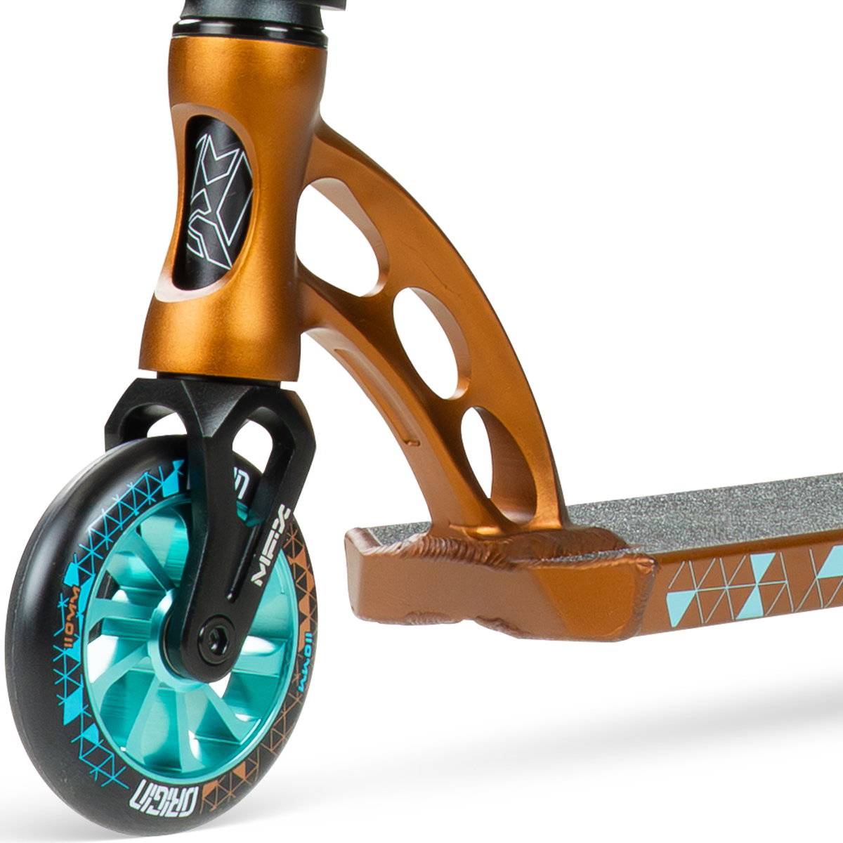 Close-up of the Madd Gear MGP VX Origin IV 500 Complete Stunt Scooter - Deltoid, showing its metallic bronze fork with cut-outs, teal wheel, and geometric-patterned deck.