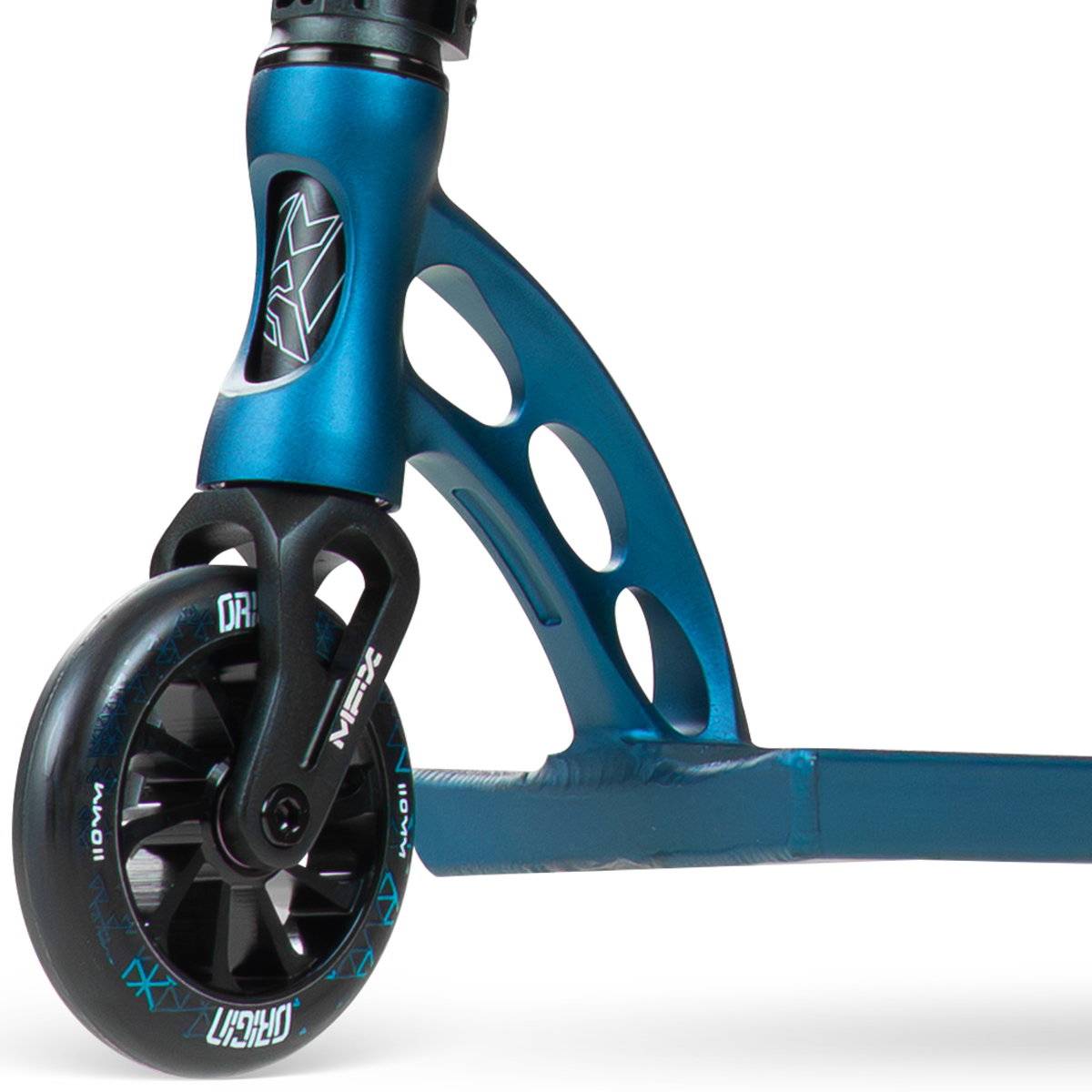 Close-up of the front wheel and fork on the denim Madd Gear (MGP) VX Origin IV 550 Complete Stunt Scooter, featuring metal cut-out details and a black wheel with white lettering—ideal for park riders wanting style and performance.