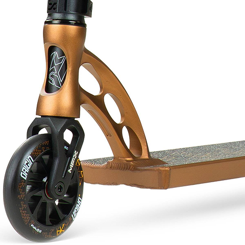 Close-up of the front wheel and deck of the Madd Gear (MGP) VX Origin IV 550 Complete Stunt Scooter - Rust, showing the fork, head tube with logo, cut-out design, wide deck, and grip tape.