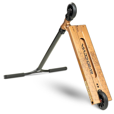 A Madd Gear (MGP) VX Origin IV 550 Complete Stunt Scooter in Rust lies on its side, showcasing the MGP logo and geometric patterns on its wide deck. The scooter features black handlebars and wheels.