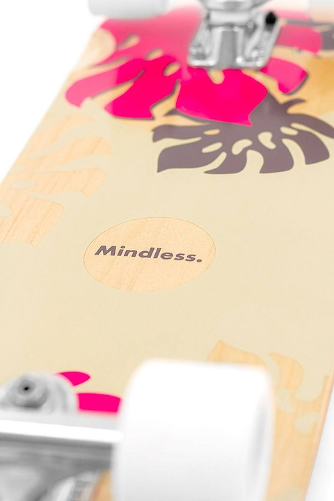 Close-up of the Mindless Oasis Cruiser Skateboard 32″ x 9″ - Natural, featuring pink and dark brown tropical leaf graphics, white wheels, and premium ABEC 9 Chrome bearings.