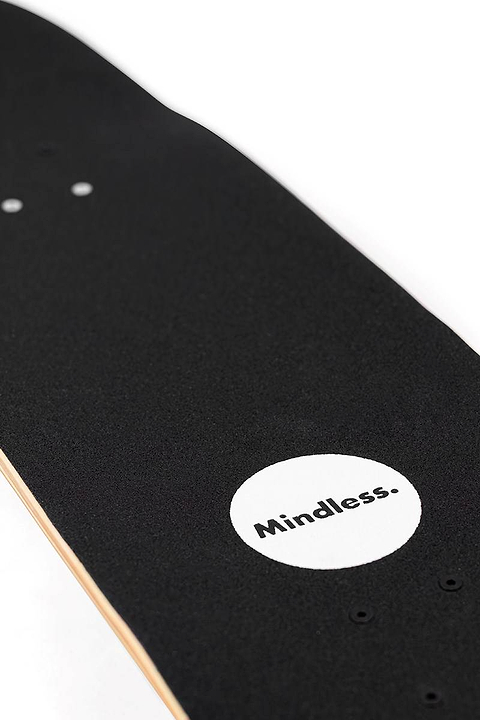 Close-up of the Mindless Oasis Cruiser Skateboard 32″ x 9″ - Natural shows its black maple deck, white circle near the tail with “Mindless.” print, grip tape detail, and Oasis Cruiser ABEC 9 Chrome bearings.