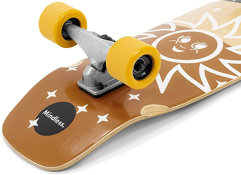 The Mindless Soul Surf Skate Cruiser Skateboard 29.5″ x 9.75″ - Brown features a brown deck with yellow wheels, a smiling sun and white stars graphic, and “Mindless” printed near the rear truck.