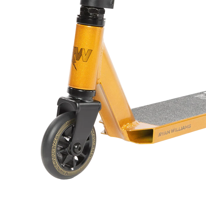 Close-up of the Nitro Circus Ryan Williams Junior Replica 2025 Complete Stunt Scooter in gold/black, featuring metallic finish, black fork, front wheel, black grip tape, and "RYAN WILLIAMS" branding on the deck.