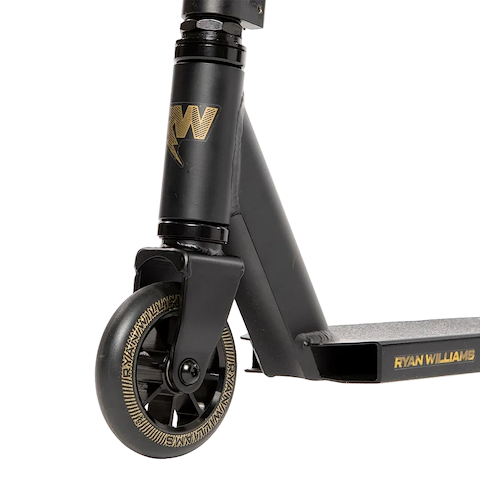 Close-up of the front wheel and deck of the Nitro Circus Ryan Williams Junior Replica 2025 Complete Stunt Scooter in black, showing gold accents and "Ryan Williams" details.
