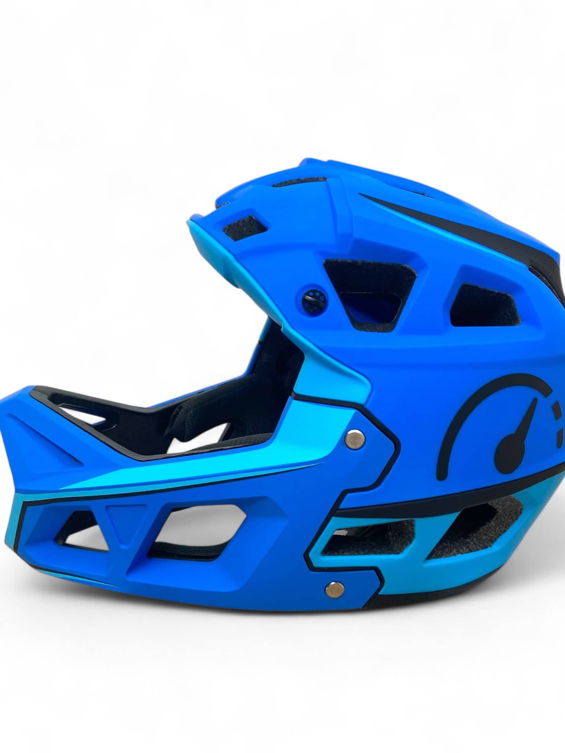 The Revvi Kids Full Face MTB Helmet - Blue by Revvi is a lightweight kids’ helmet featuring black accents, open vents, and a speedometer graphic on the side. It’s displayed on a white background.