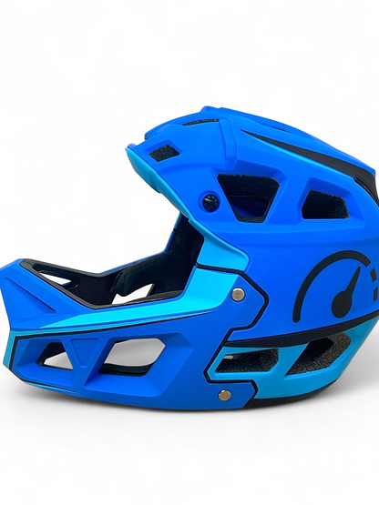 The Revvi Kids Full Face MTB Helmet - Blue by Revvi is a lightweight kids’ helmet featuring black accents, open vents, and a speedometer graphic on the side. It’s displayed on a white background.