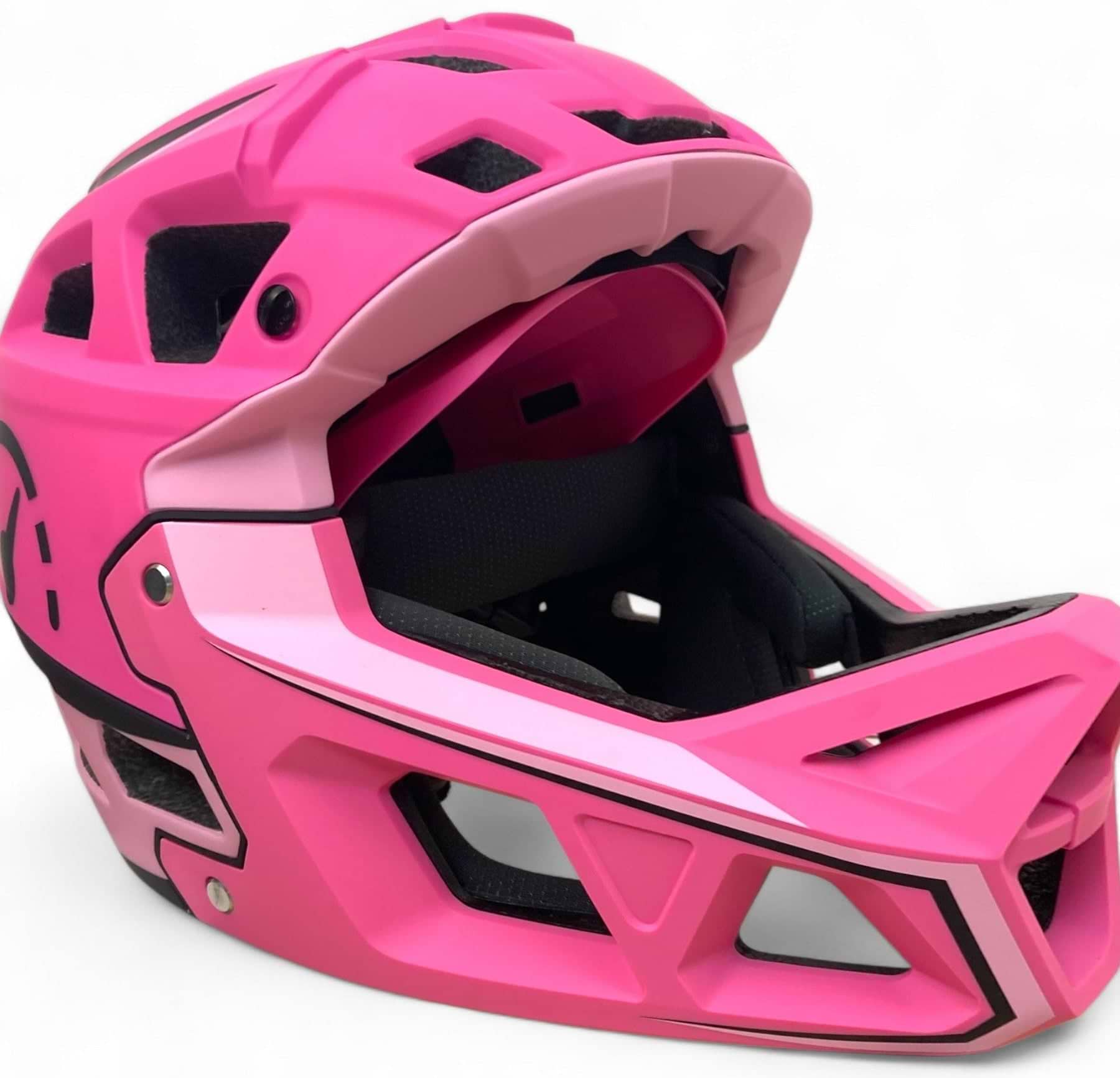 The Revvi Kids Full Face MTB Helmet - Pink by Revvi features black and light pink accents, a sturdy chin guard, ventilation openings, and a matte finish. This lightweight mountain bike helmet is displayed against a plain white background.