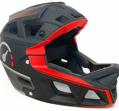 The Revvi Kids Full Face MTB Helmet - Black by Revvi features angular vents, a visor, and internal padding for comfort. This adjustable helmet ensures a secure fit and stylish head protection for young mountain bike riders.