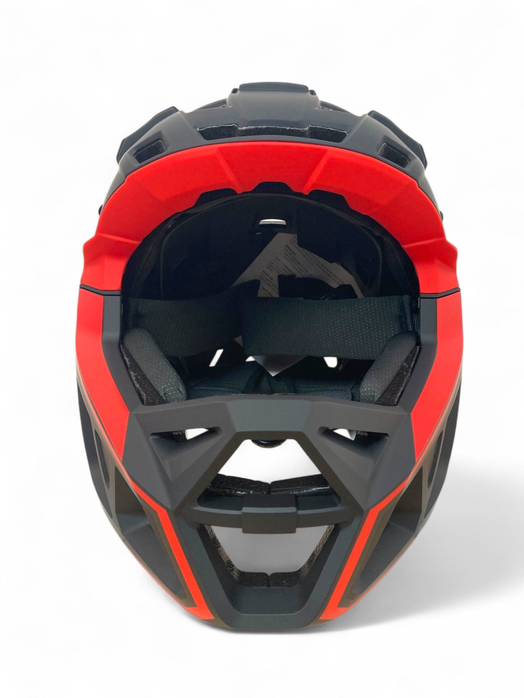 Front view of the Revvi Kids Full Face MTB Helmet in Black by Revvi, featuring interior padding and a chin guard, photographed against a white background.