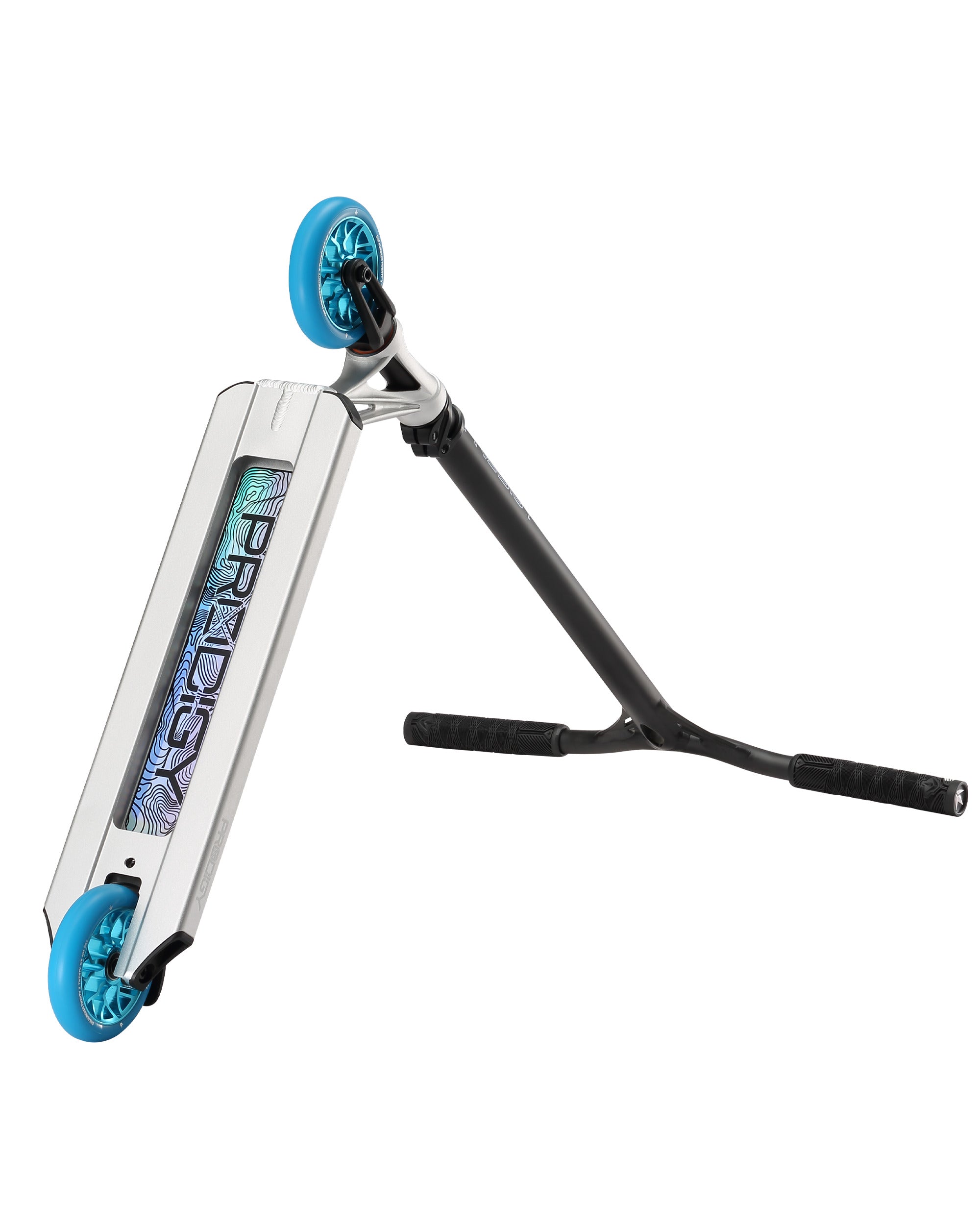 The Blunt Envy Prodigy X ONE Complete Stunt Scooter in silver features blue wheels, black handlebars, and an iridescent "Prodigy" logo on its deck, shown lying on its side with the handlebars resting on the ground.