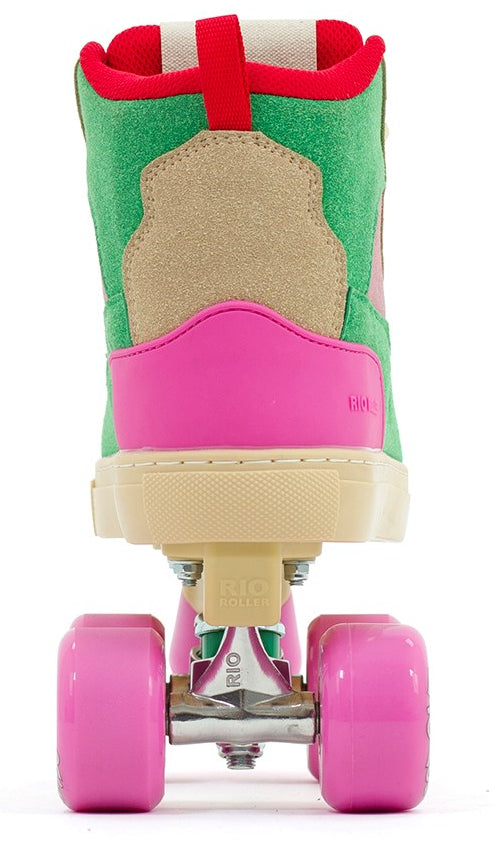 The Rio Roller Beats Quad Roller Skates by Rio Roller feature a colorful vegan design in pink and green, tan and red accents, bright pink wheels, and a red pull loop at the back.