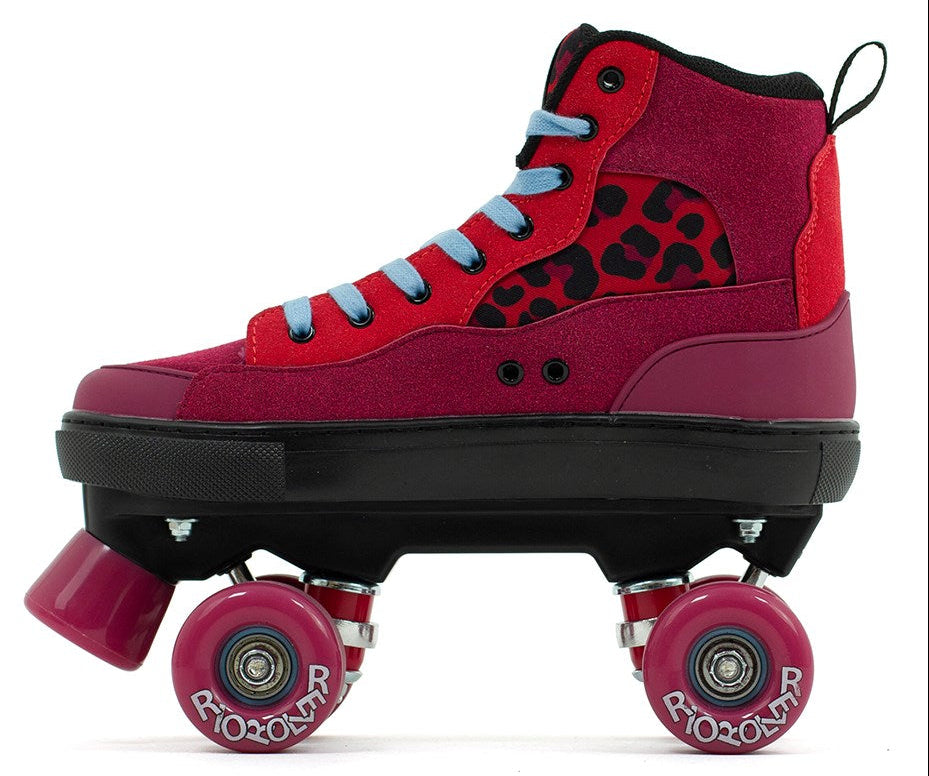 The Rio Roller Beats Quad Roller Skates in red/leopard feature a retro high-top style with light blue laces, leopard print panel, four pink wheels, and bold "RIO ROLLER" branding. They're vegan-friendly for a standout look.