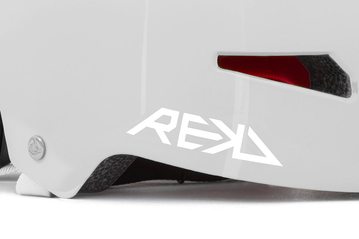 Close-up of the REKD Elite 2.0 Skate / Scooter Helmet in gloss silver, a certified REKD helmet for action sports, featuring bold branding, silver shell with vent details, and textured black interior padding.