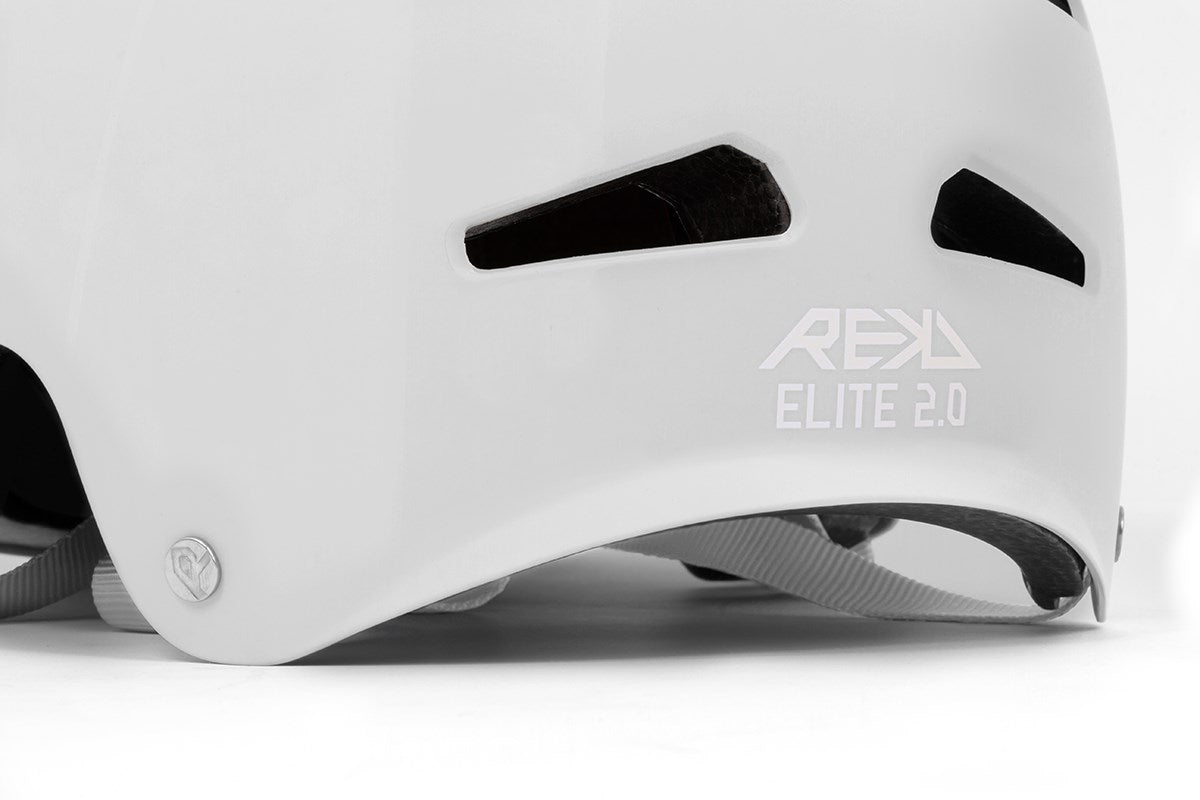 Close-up of the back of the REKD Elite 2.0 Skate / Scooter Helmet in gloss silver by REKD, featuring black vents, gray straps, and "REKD ELITE 2.0" printed on it.