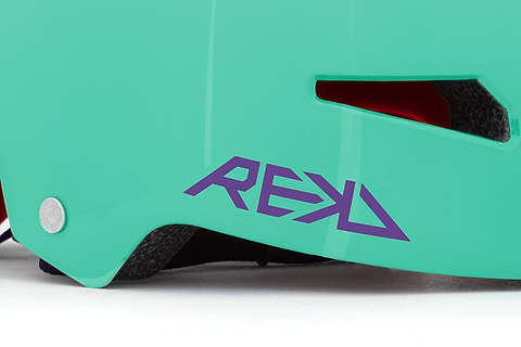 Close-up of the REKD Elite 2.0 Skate / Scooter Helmet in Gloss Teal, featuring a purple REKD logo, silver rivet, visible vent, and inner padding.