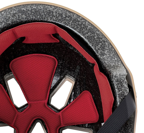 Close-up of the inside of the REKD Elite 2.0 Skate / Scooter Helmet in Peach / Purple, featuring red padding, black straps, and grey foam by REKD for impact protection.