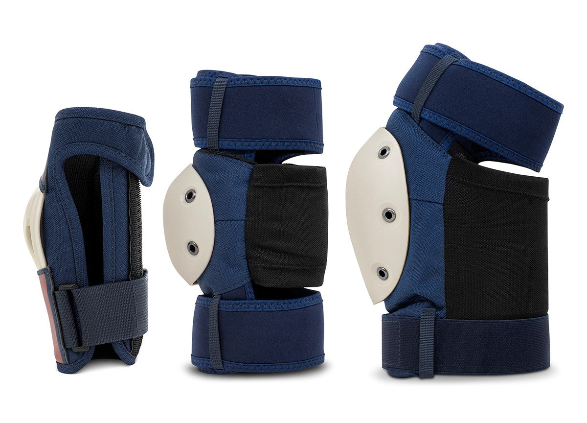 Three REKD Shield Triple Skate Protection Pad Sets in blue, featuring black accents and white hard shells, are displayed from multiple angles against a white background—a versatile protective gear set by REKD, ideal for action sports.