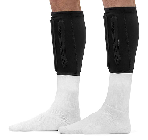 REKD Energy Covert Short Shin Skate Protection Guards in black worn over white socks on a person’s lower legs, providing slim impact protection.