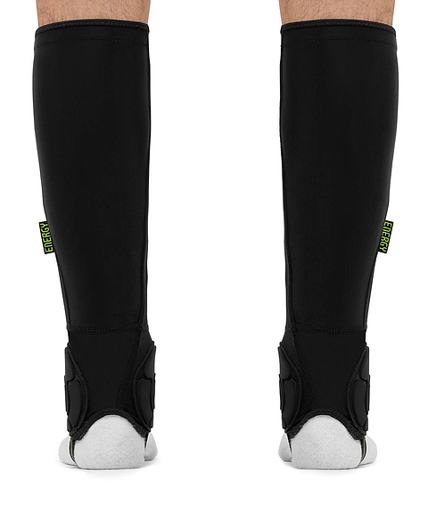 Black REKD Energy Covert Long Shin and Ankle Skate Protection Guards worn on the lower legs, featuring a small “ENERGY” tag on the side of each guard.