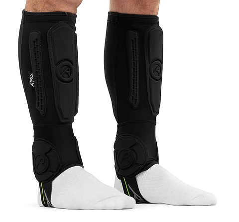 Pair of black REKD Energy Covert Short Shin and Ankle Skate Protection Guards worn over white socks for BMX protection.