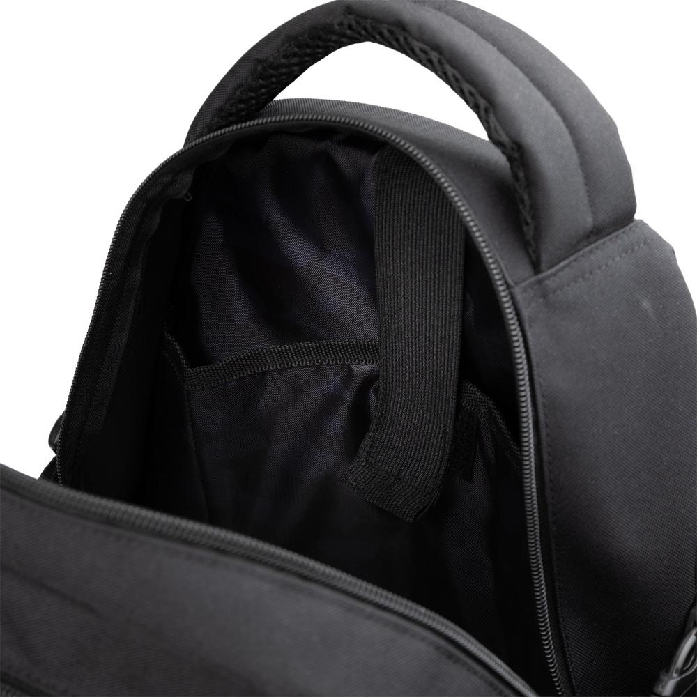 A close-up view of the inside of the Rookie Skatepack Classic 78 25 L Backpack by Rookie in black, featuring an open zipper, a padded handle, and an inner compartment with a fabric divider and strap—perfectly organized for any skate backpack enthusiast.