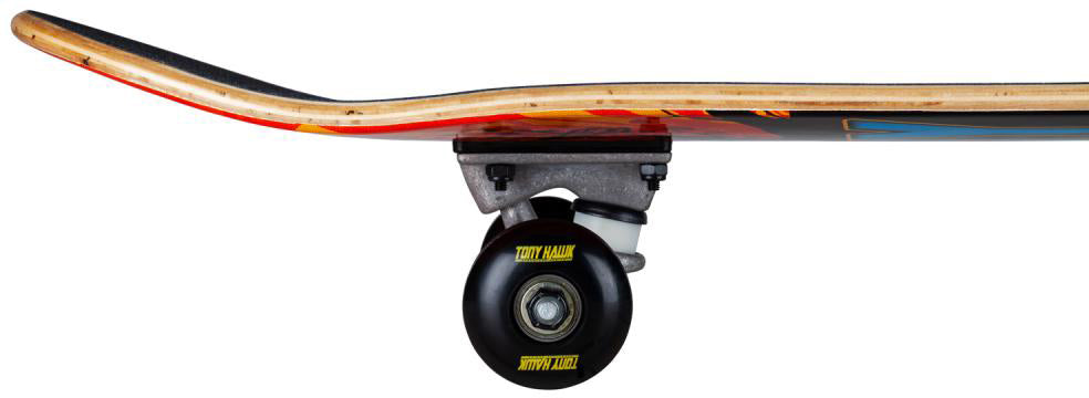 Side view of the Tony Hawk SS 180 Series Shatter Logo Complete Skateboard (7.75″ x 31″), featuring a durable maple deck with a curved nose and tail, sturdy metal trucks, and black wheels highlighted by yellow “TONY HAWK” text. The underside displays a colorful Shatter Logo graphic, making this skateboard from Tony Hawk an excellent choice for beginners.