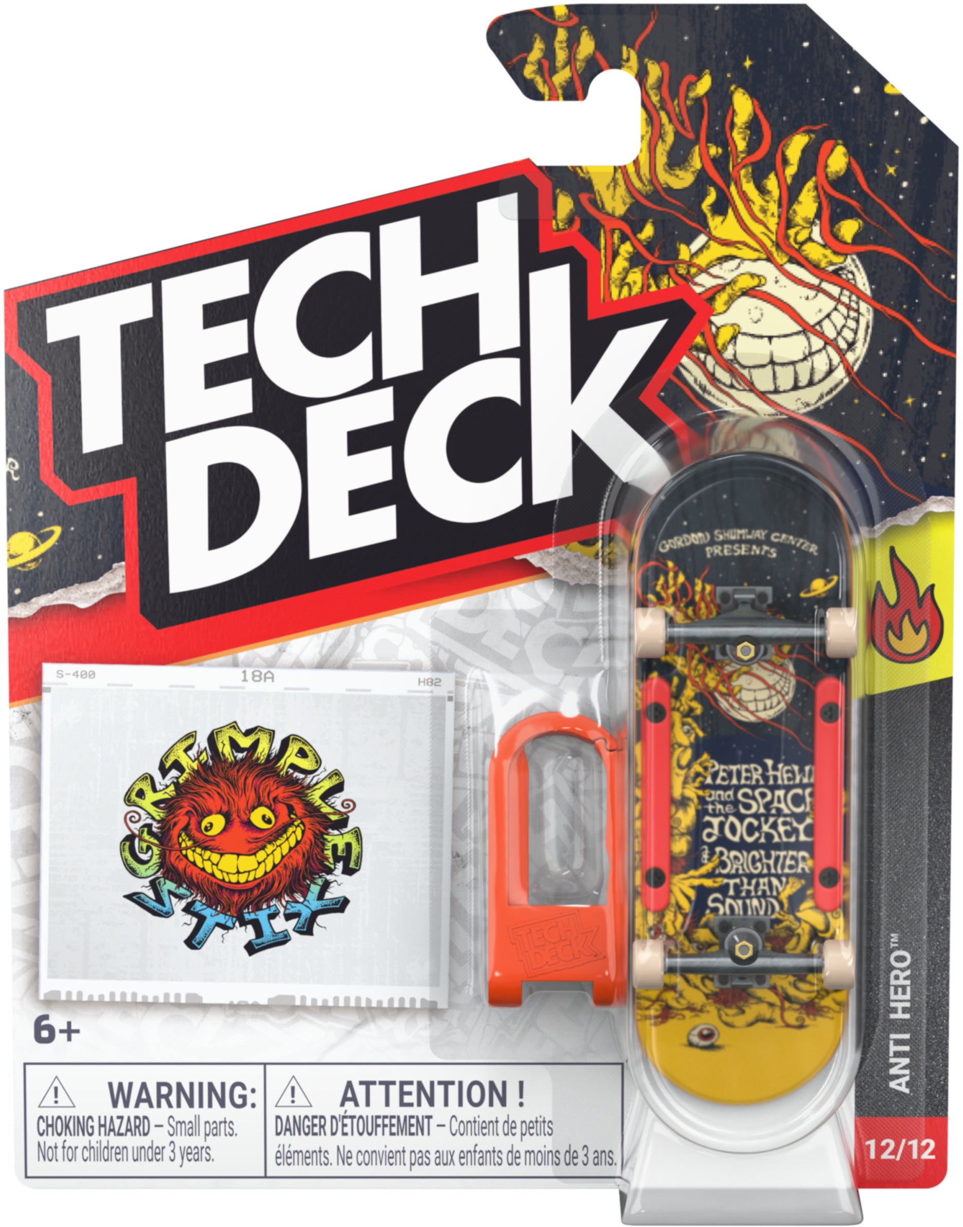 A Tech Deck 96mm M61 Fingerboard - Anti Hero with a yellow and black graphic in retail packaging, including a sticker and a small plastic tool for collectors.
