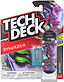 A Tech Deck 96mm M61 Fingerboard - Disorder featuring an illustrated face graphic, displayed in its original retail packaging with a plastic tool.