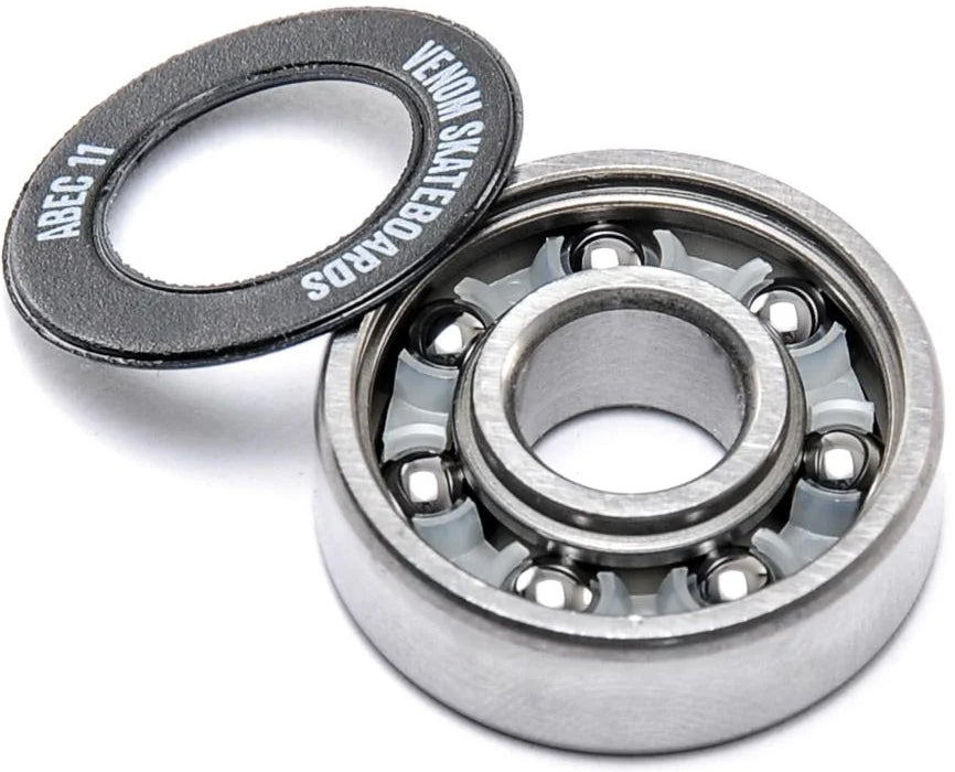 A Venom ABEC 11 Skateboard Bearings - 8 Pack shown with its detached black rubber shield, displaying the brand name and precision rating.