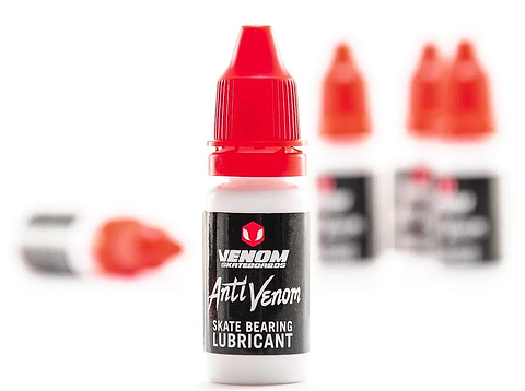 A small 10ml bottle of Venom AntiVenom Bearing Lube with a red twist-top cap, labeled with white text on a black background for skateboard bearings.