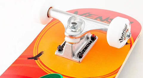 Close-up of a Venom Junior Desert Viper Kids Complete Skateboard - 7.25″ x 29″ featuring a sunset and bird graphic, with a silver truck and white wheels attached.