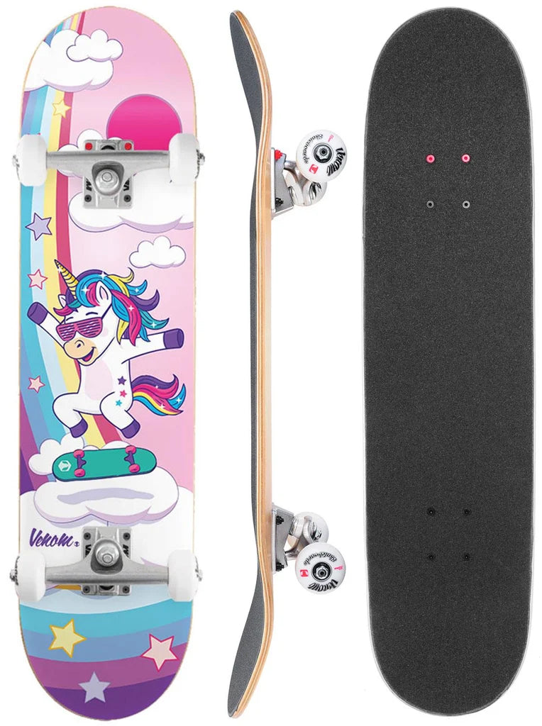 Three views of a Venom Junior Unicorn Flip Kids Complete Skateboard: the top with black grip tape, the side profile showing the deck and trucks, and the underside featuring a cartoon unicorn with sunglasses on a rainbow background.