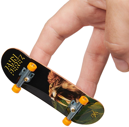 A hand uses two fingers to maneuver a Tech Deck M01 Deluxe 4 Pack Fingerboard by Maxallure, featuring yellow wheels and a lion graphic on the underside.