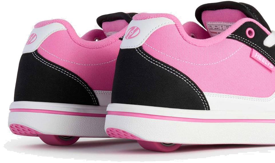 A close-up of Heelys Pro 25 V2 Girls Shoes in Black, White, and Pink by Heelys, showcasing their signature wheels in the heels against a white background—ideal for fans of retro fashion and classic 90s style.