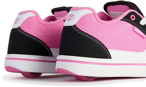 A close-up of Heelys Pro 25 V2 Girls Shoes in Black, White, and Pink by Heelys, showcasing their signature wheels in the heels against a white background—ideal for fans of retro fashion and classic 90s style.
