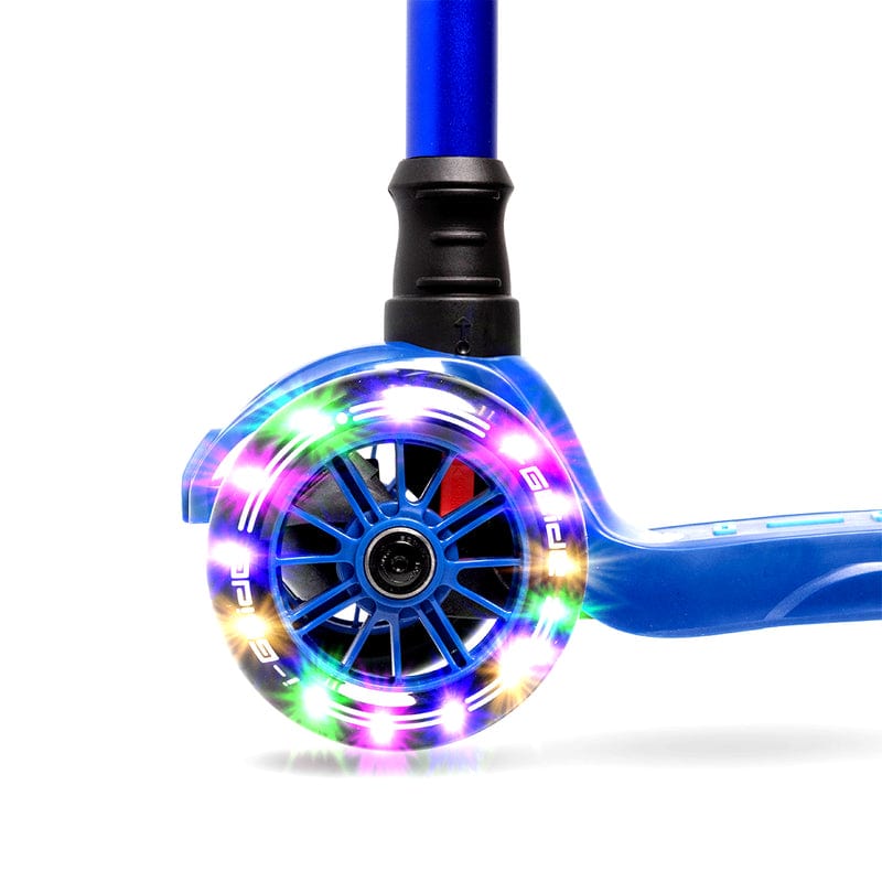 Close-up of the I-Glide 3-Wheel LED Kids Scooter's blue wheel, illuminated by vibrant LED lights forming a radiant ring. The multicolored glow, showcasing red, green, blue, and yellow shades, accentuates the scooter's design. The partially visible frame includes an adjustable height handlebar.