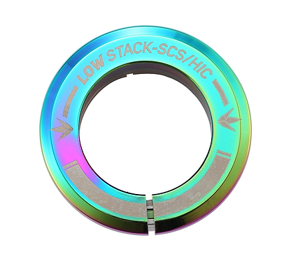 The Blunt Envy Low Stack SCS Integrated Stunt Scooter Headset in Oil Slick Neochrome is a metallic, iridescent piece designed for an SCS Stunt Scooter. It features engraved arrows and a slit across the bottom, with its rainbow-like sheen enhancing its role in the compression system.