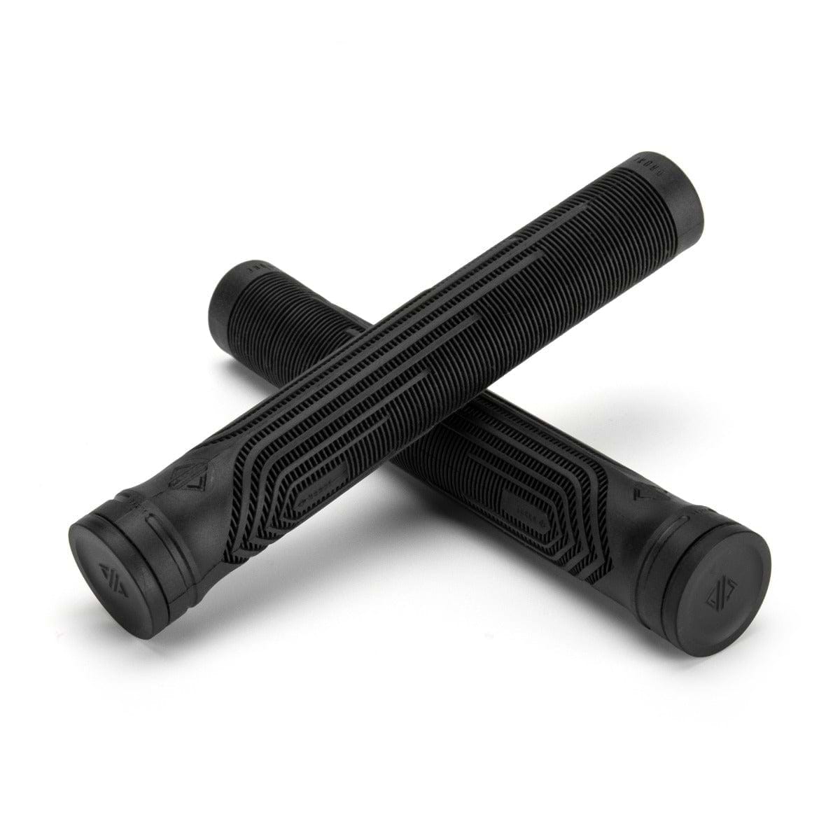 Two Drone Acolyte Black Stunt Scooter Grips, each 180mm in length, are artfully crossed over one another against a clean, white backdrop. Adorned with futuristic linear designs and featuring flat ends crafted from Comfort Max silicone, these grips promise an unmatched riding experience.