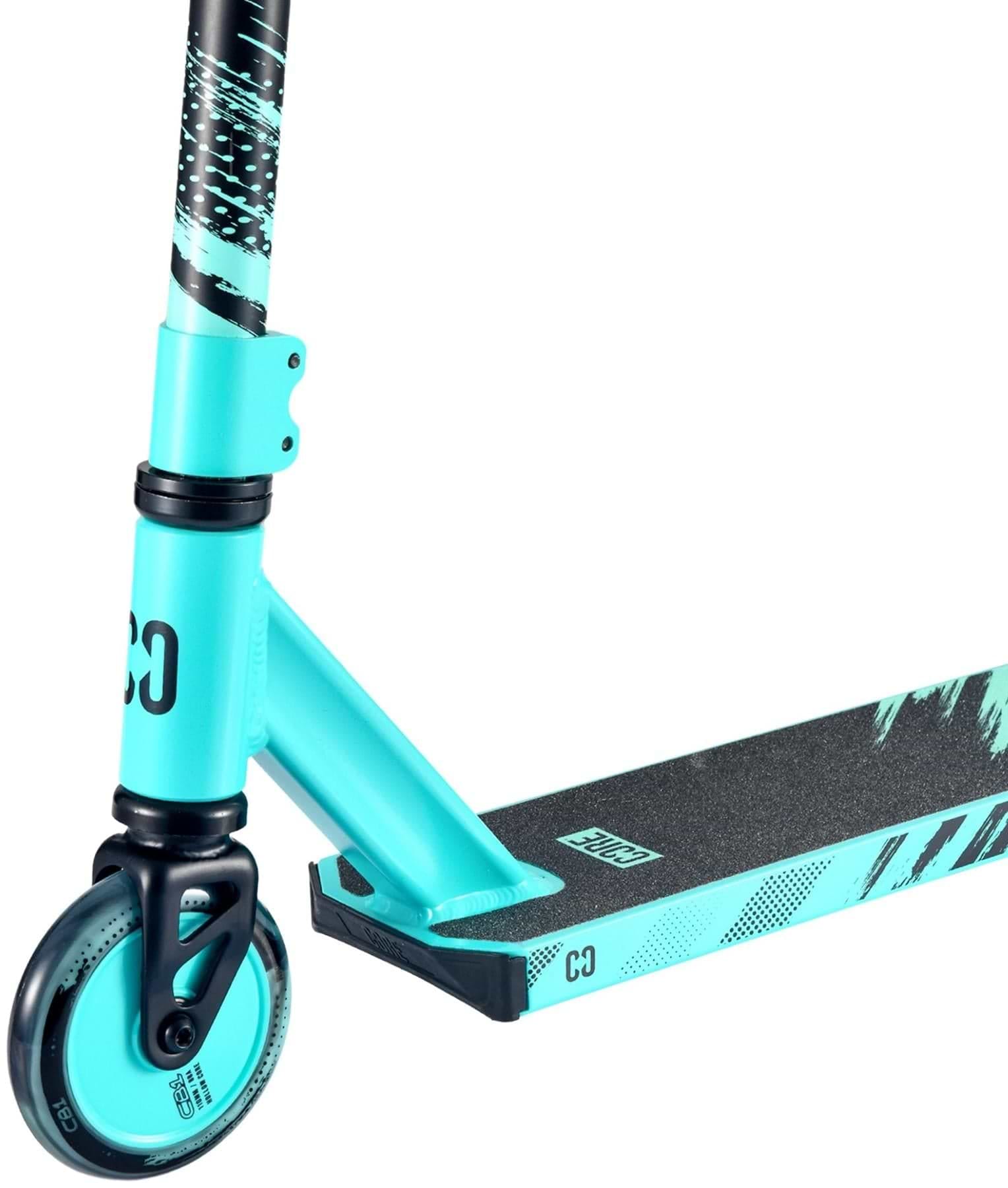 A close-up of the CORE CB1 Beginner Complete Stunt Scooter in teal and black by CORE, highlighting its front wheel, fork, and grippy deck with graphics—perfect as a starter scooter for beginners.