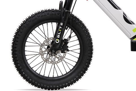 Close-up of a thick, knobby front tire with disc brake on the Duo 20" Blitz Kids Electric Balance Bike in white/black. The black fork shows "BLITZ" in white and green; the white frame has black and green accents.