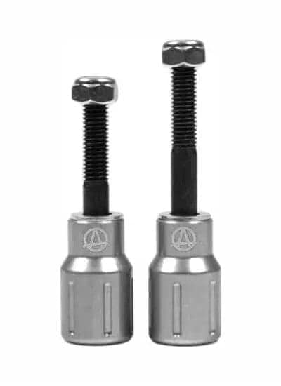 Two metal fasteners with nuts and threaded bolts resemble Apex Barnaynay Aluminium Stunt Scooter Pegs from Apex, featuring cylindrical bases engraved with a logo. The fastener on the left is slightly shorter than the one on the right. Both are in a raw silver finish with black threaded sections.