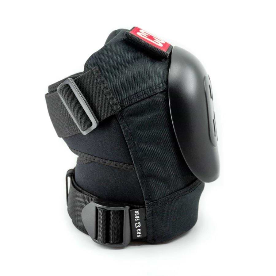 Introducing the CORE Pro Park Knee V2 Skate Protection Pads by CORE, featuring adjustable straps and a hard plastic cap—ideal for skatepark riders. These pads come with a distinctive red tag on top, making them suitable for skateboarding and other sports. Their ergonomic and durable design integrates a Dynamic Size System to ensure an optimal fit.