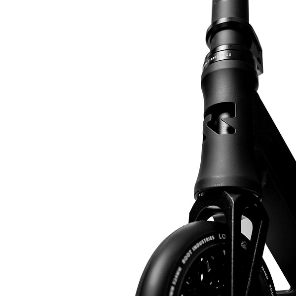 Close-up of a sleek black scooter frame against a white background, reminiscent of the precision seen in Root Industries' Type R GT Complete Stunt Scooter, highlighting the handlebars and top of the front wheel.